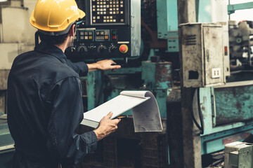 Wall Mural - Skillful factory worker working with clipboard to do job procedure checklist . Factory production line occupation quality control concept .