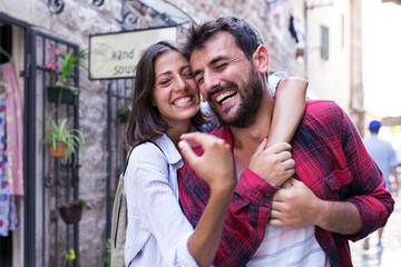 Wall Mural - Happy love couple walking in town