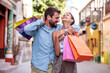 © ivanko80 - Happy young couple in the city after shopping