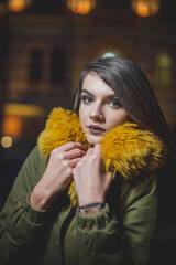 Wall Mural - Shallow focus shot of a confident Caucasian female in a puffer posing for the camera