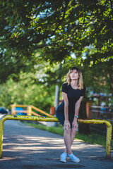 Wall Mural - Attractive Caucasian woman from Bosnia and Herzegovina in a black dress posing in a park