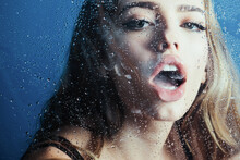 Fashion Beauty And Love. Window With Water Drops Before Sensual Girl. Rain Drops On Window Glass In Heart Shape. Sexy Woman Behind Window With Water Drops.