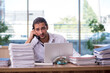 © Elnur - Young male employee unhappy with excessive work in the office