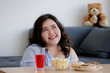 © Bangkok Click Studio - Happiness of Asian young sexy confidence smart beautiful long black hair oversized fat female model sit relax smiling thinking about food snack and drink on table in blurred foreground and background