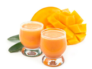 Sticker - exotic juicy mango fruits and two glasses of fresh natural mango juice isolated on white background