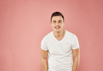 Cute man in t-shirt studio pink background fun