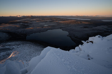 Lake Will and distant Mount Ossa on a winter dawn from Barn Bluff in the Cradle Mountain Lake St Clair National Park. Tasmania