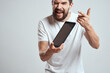 © SHOTPRIME STUDIO - A bearded man in a white t-shirt a tablet in the hands of a professional manager communication technology