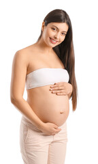 Wall Mural - Young pregnant woman on white background