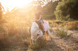 little boy on top of a pony in the field at sunset. Child riding a little horse, pony