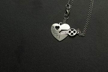 Canvas Print - Pendant of best friends heart and key necklace silver color closeup. Selective Focus. High quality photo