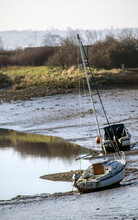 Two Boats At Low Tide On The River