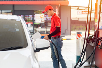 Wall Mural - Gas station male man worker staff happy service working refill car gasoline fuel to traveler cars