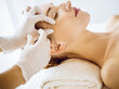 © rogerphoto - Beautiful woman receiving beauty injections with closed eyes in medical center. Beautician doctor hands doing beauty procedure to female face with syringe. Cosmetic medicine and surgery concept