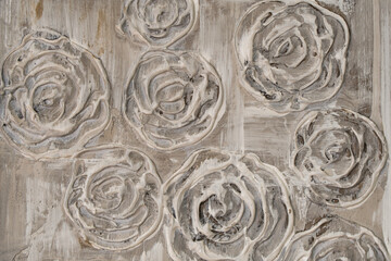 Abstract textured background of grungy rose shaped ornament covering shabby gray concrete wall