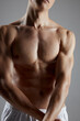 © SHOTPRIME STUDIO - athlete with muscular body in white shorts joined hands on gray background cropped view