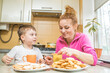© Павел Костенко - Portrait of mom and son drinking tea at home in the kitchen