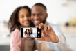 © Prostock-studio - Cheerful african american father taking selfie with smiling daughter