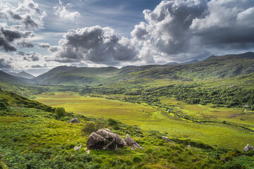 Beautiful Molls Gap illuminated by sunlight with Owenreagh River valley and MacGillycuddys Reeks mountains, Wild Atlantic Way, Ring of Kerry, Ireland