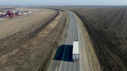 Wall Mural - Aerial Top View of White Truck with Cargo Semi Trailer Moving on