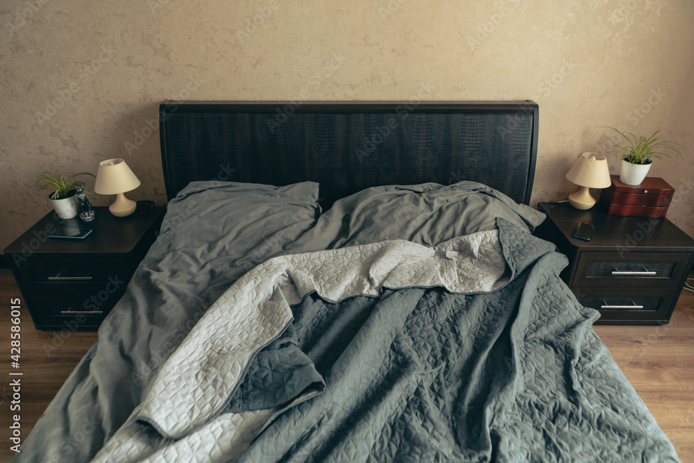 empty messy bed with grey sheets - obrazy, fototapety, plakaty 