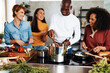 © Flamingo Images - Diverse friends cooking together