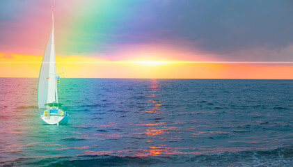 Wall Mural - Yacht sailing in open sea at stormy day - Anchored sailing yacht on calm sea with tropical storm and double sided rainbow in the background