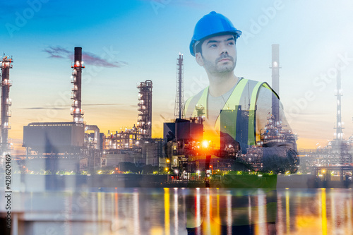 Double exposure of smart engineer maintenance in solar power plant checking installing photovoltaic solar modules with digital tablet with Oil and gas refinery industry plant background.