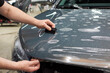 © Светлана Акифьева - Installation of a protective paint and varnish transparent film on the car. PPF polyurethane film to protect the car paint from stones and scratches.