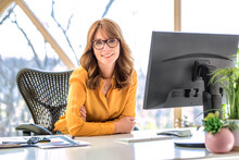 Middle Aged Businesswoman Sitting Behind Her Computer While Working From Home