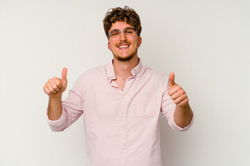 Young caucasian man isolated on white background raising both thumbs up, smiling and confident.