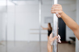 Women on pole dance training, dancing in class
