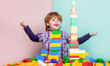 © Yevhen - Little boy playing with lots of colorful plastic blocks constructor. Boy playing with construction blocks at kindergarten. Child playing with colorful toy blocks. Educational toys for young children