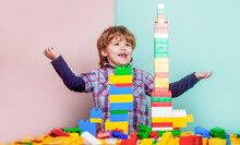 Little Boy Playing With Lots Of Colorful Plastic Blocks Constructor. Boy Playing With Construction Blocks At Kindergarten. Child Playing With Colorful Toy Blocks. Educational Toys For Young Children