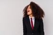 © Asier - Young African American business woman wearing a suit isolated on white background shouting towards a copy space