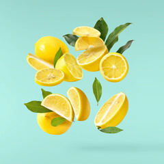 Wall Mural - creative image with fresh lemons falling in the air, zero gravity food conception