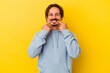 © Asier - Young caucasian man isolated on yellow background smiles, pointing fingers at mouth.