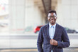 © Dragana Gordic - Portrait of smiling businessman. Handsome young man in eyeglasses looking at camera. Concept of confidence. Young African businessman exploring the city