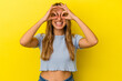 © Asier - Young blonde caucasian woman isolated on yellow background excited keeping ok gesture on eye.