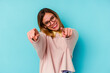 © Asier - Young student caucasian woman isolated on blue background cheerful smiles pointing to front.