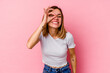 © Asier - Young caucasian woman isolated on pink background excited keeping ok gesture on eye.