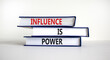 Influence is power symbol. Books with words 'Influence is power'. Beautiful white background. Business, influence is power concept, copy space.