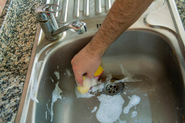 Wall Mural - Cleaning the dirty sink with a sponge
