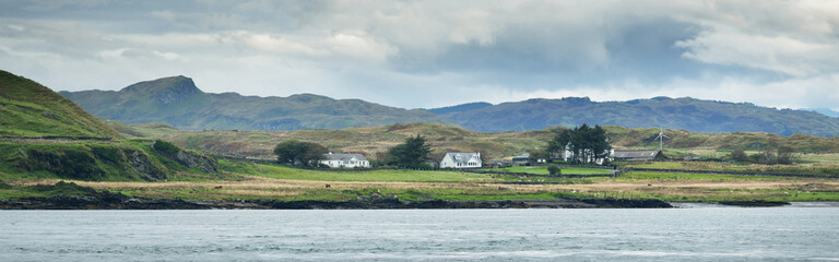 Wall Mural - Panoramic view of the cliffs, mountains and valleys of the islands of Inner Hebrides. Scotland, UK. Dramatic sky, stormy clouds. Nature, travel destinations, cruise, tourism concepts