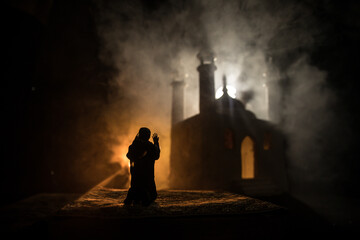 silhouette of mosque building on toned foggy background. ramadan kareem background. mosque at sunset