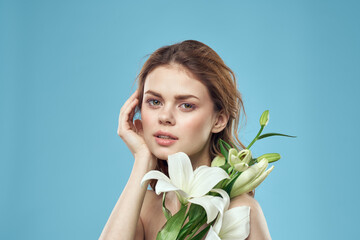 Attractive Lady white flowers blue background portrait cropped view