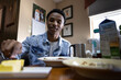 Young African American Teen Enjoying a Meal at Home