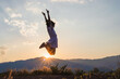 © AungMyo - Silhouette of happy child jumping playing on mountain at sunset time