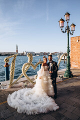 Wall Mural - Romantic walk of the bride and groom on the shores of the Italian Gulf.