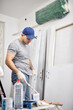 © astrosystem - Young adult man working on a DIY budget renovation of his new home apartment.